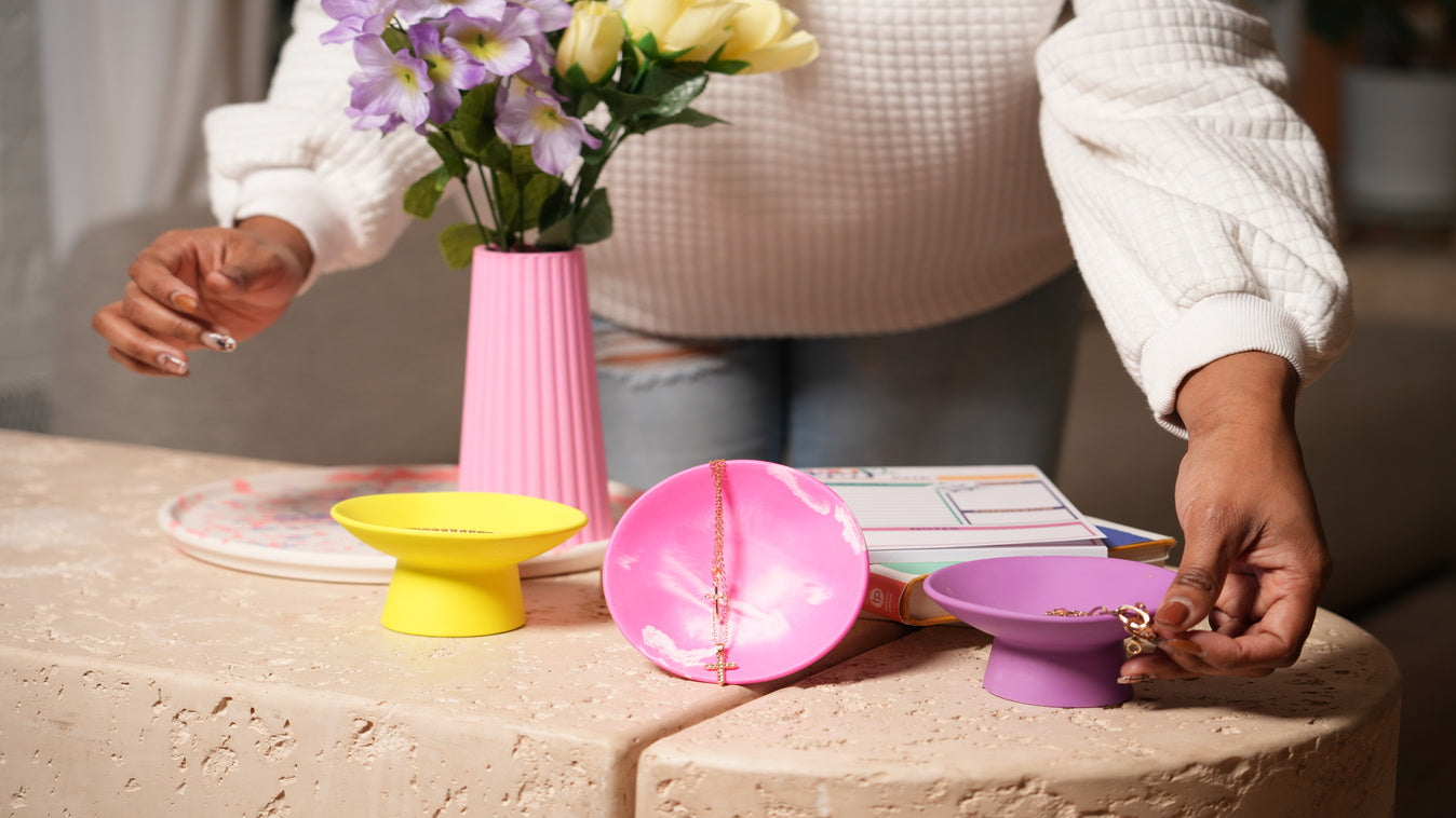 Pink Purple Yellow Jewelry Tray with person putting jewelry in the trays